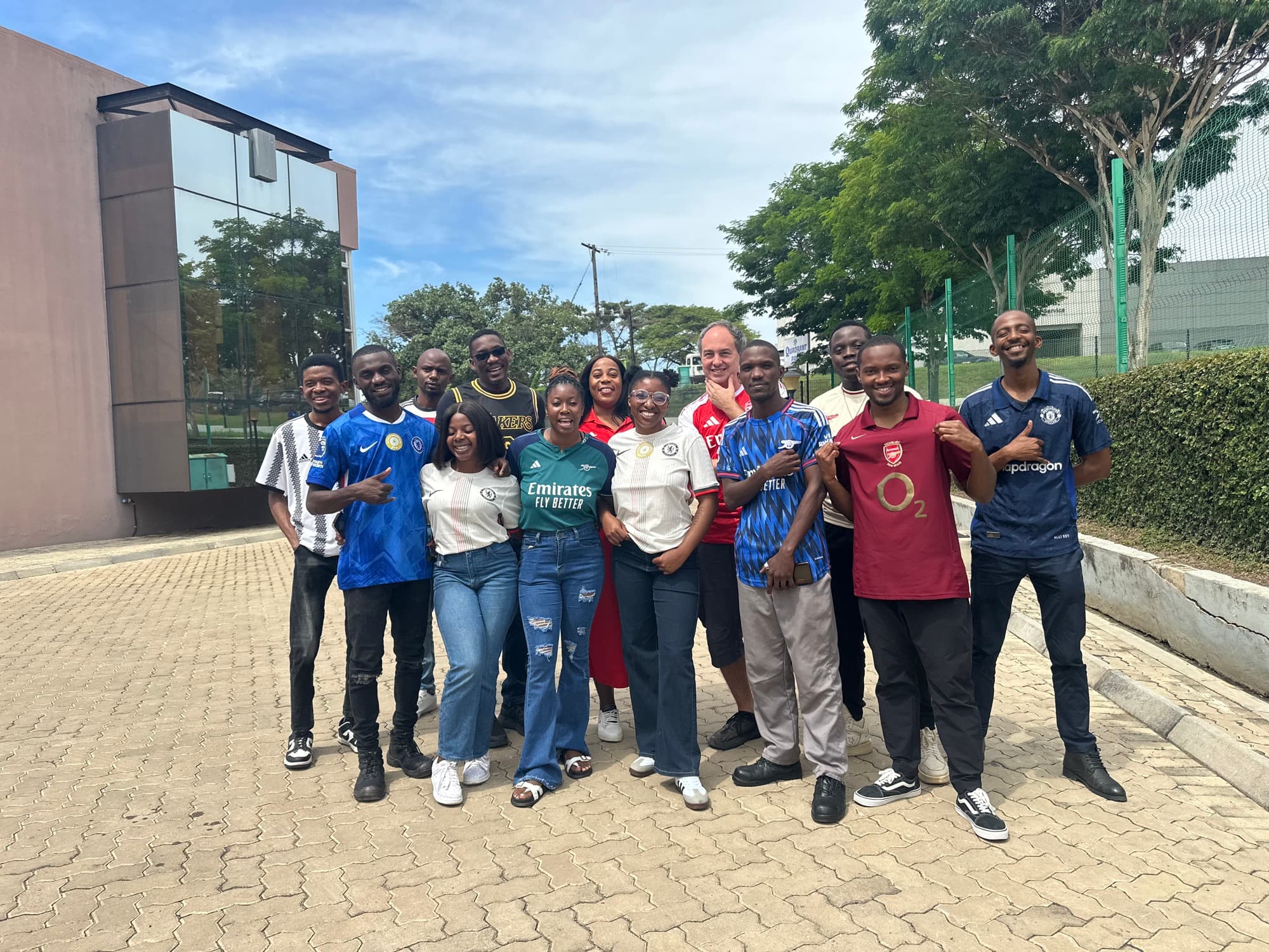 The Ballo Innovations team outside the office in football shirts